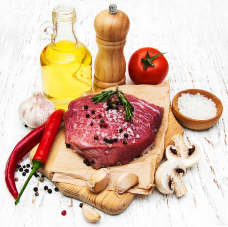 fillet of beef and ingredients on a old wooden backgroundの写真素材