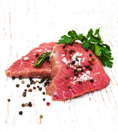fillet of beef and ingredients on a old wooden backgroundの写真素材