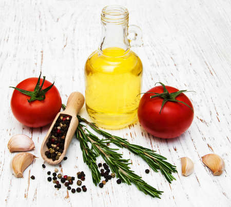 olive oil,  tomato and garlic on a wooden backgroundの写真素材
