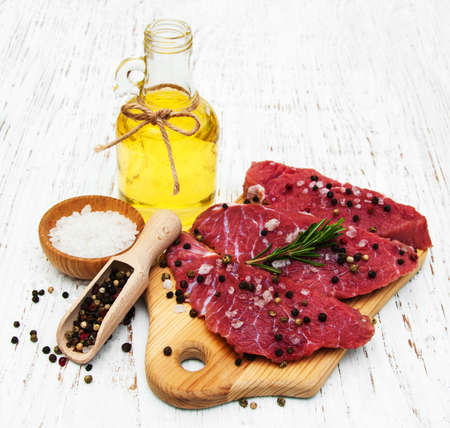 fillet of beef and ingredients on a old wooden backgroundの写真素材