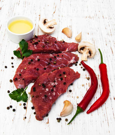 fillet of beef and ingredients on a old wooden backgroundの写真素材