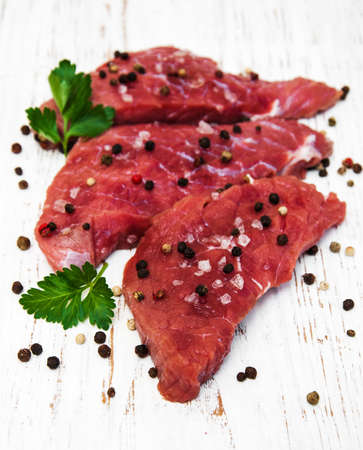 fillet of beef and ingredients on a old wooden backgroundの写真素材