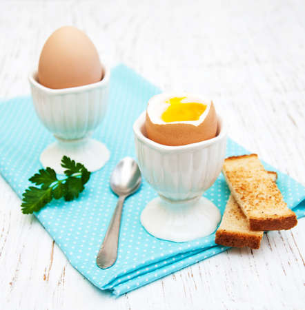boiled eggs for breakfast on a old wooden tableの写真素材