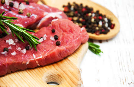 fillet of beef and ingredients on a old wooden backgroundの写真素材