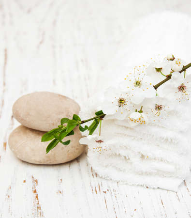 Cherry blossom, vassage stone and towels on a wooden backgroundの写真素材