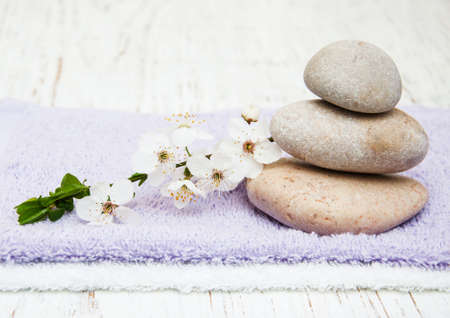Cherry blossom, vassage stone and towels on a wooden backgroundの写真素材