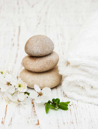 Cherry blossom, vassage stone and towels on a wooden backgroundの写真素材
