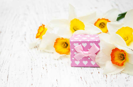 Yellow daffodils with present box on a old wooden backgroundの写真素材