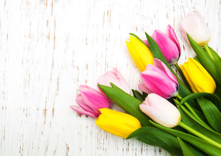bouquet of pink and yellow tulips  on a wooden backgroundの写真素材