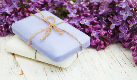 Natural handmade soap and lilac flowers on a wooden backgroundの写真素材