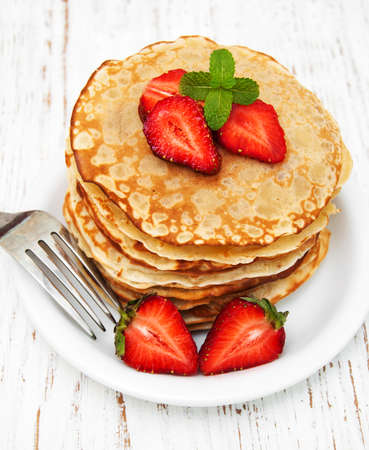 Pancakes with strawberries on a wooden backgroundの写真素材