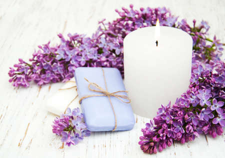 Natural handmade soap and lilac flowers on a wooden backgroundの写真素材