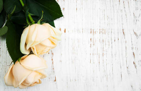 Two Roses on a old wooden tableの写真素材