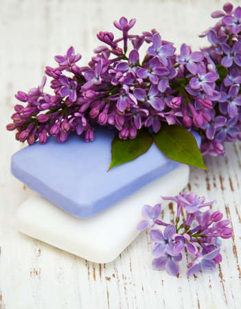 Natural handmade soap and lilac flowers on a wooden backgroundの写真素材