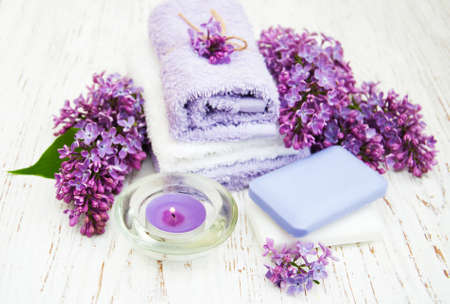 Spa concept - natural soap, towels and lilac flowersの写真素材