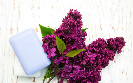 Natural handmade soap and lilac flowers on a wooden backgroundの写真素材