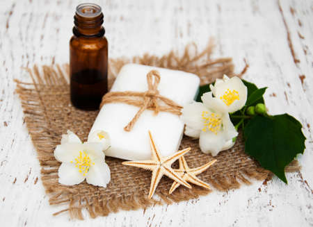 essential oil and soap with jasmine flower on a wooden backgroundの写真素材