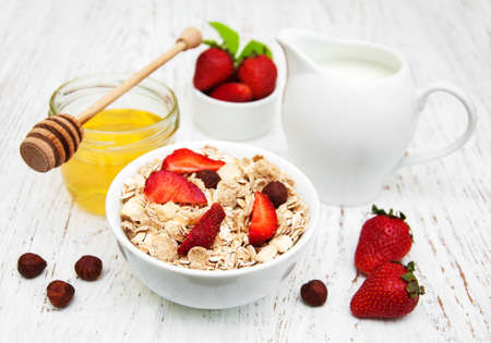 Muesli with strawberries on a old wooden backgroundの写真素材
