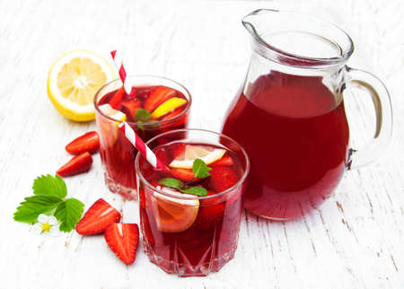 Glasses with strawberry drink on a wooden backgroundの写真素材