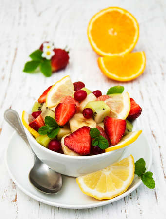 Salad with fresh fruits on a old wooden backgroundの写真素材