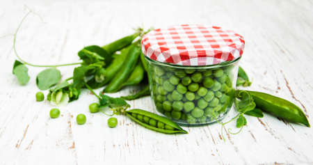 Jar with fresh peas on a old wooden backgroundの写真素材