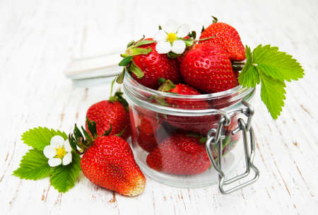 Jar with strawberries on a wooden backgroundの写真素材