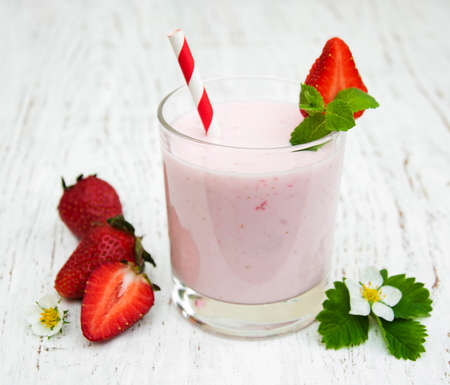 Strawberry yogurt with fresh strawberries on a wooden backgroundの写真素材