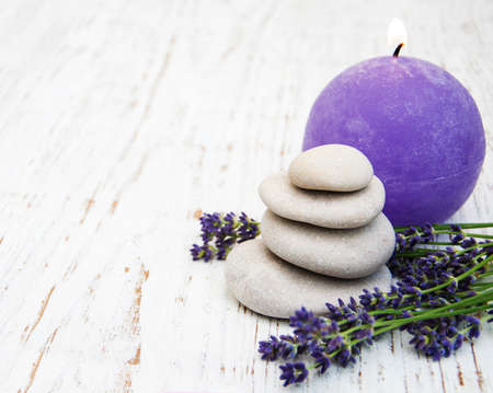 Lavender, candle and massage stones on a old wooden backgroundの写真素材