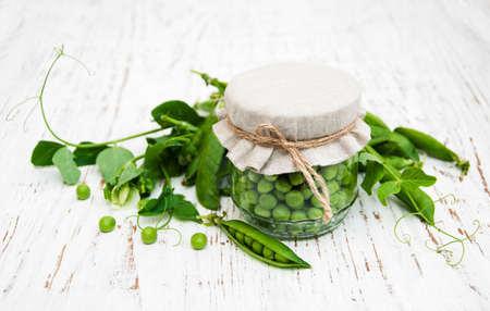 Jar with fresh peas on a old wooden backgroundの写真素材
