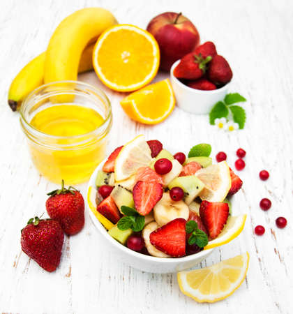 Salad with fresh fruits on a old wooden backgroundの写真素材
