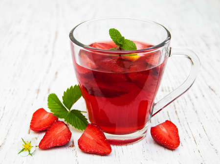 Fruit tea with strawberries  on a wooden tableの写真素材