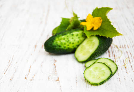 Fresh cucumbers on a old wooden backgroundの写真素材