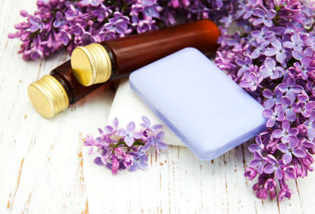 Natural handmade soap and lilac flowers on a wooden backgroundの写真素材