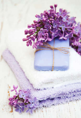 Spa concept - natural soap, towels and lilac flowersの写真素材