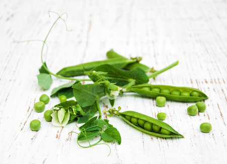 green peas with leaf and flower on a old wooden backgroundの写真素材