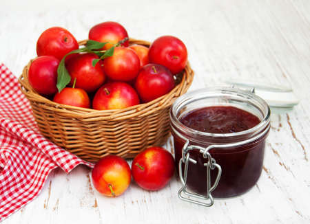 Jam with plums on a old wooden backgroundの写真素材