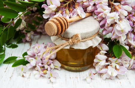 honey with acacia blossoms on a wooden backgroundの写真素材