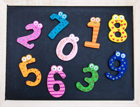 School Blackboard with funny numbers on a wooden tableの写真素材