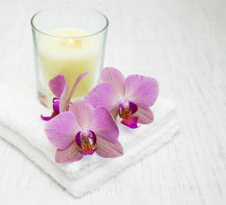 Pink orchids and towels on a wooden backgroundの写真素材