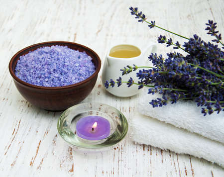 Lavender with essencial oil and candle on a wooden backgroundの写真素材