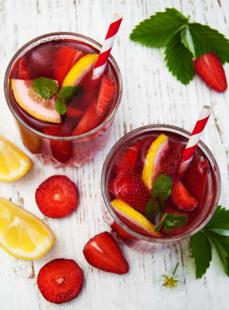 Glasses with strawberry drink on a wooden backgroundの写真素材