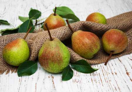 Fresh pears on a old wooden backgroundの写真素材
