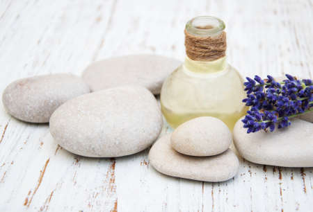 Spa products and lavender flowers on a old wooden backgroundの写真素材