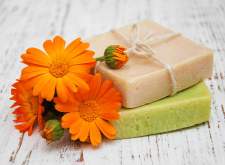 Calendula and handmade soap on a wooden backgroundの写真素材