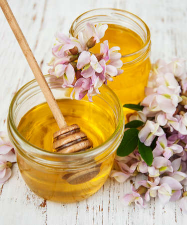 honey with acacia blossoms on a wooden backgroundの写真素材