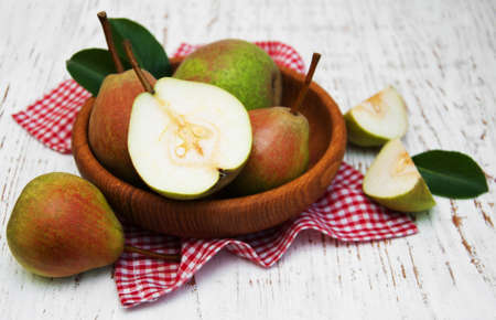 Bowl with pears on a old wooden backgroundの写真素材