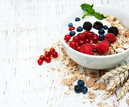 breakfast with fresh berries on a old wooden tableの写真素材