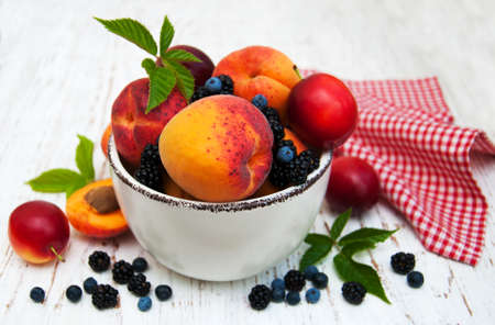 Fresh summer fruits and berries on a old wooden backgroundの写真素材
