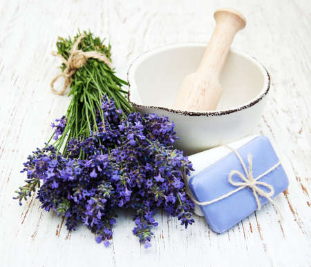 bunch of lavender flowers and mortar on a wooden backgroundの写真素材