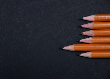 Pencils set on a school blackboard backgroundの写真素材